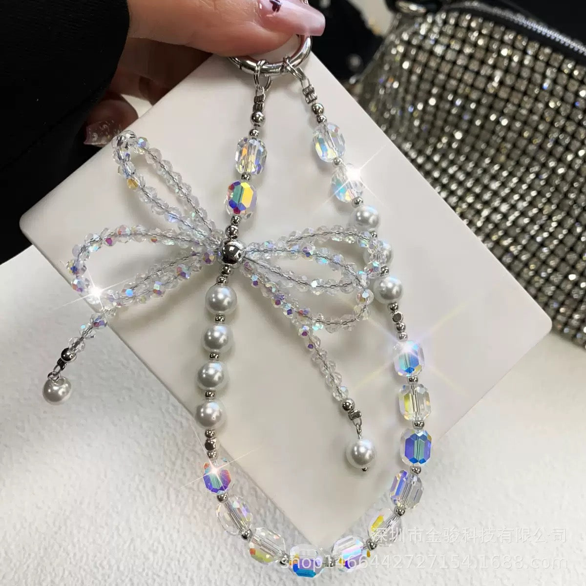 This version positions the product as an ideal gift solution with elegant packaging for special occasions.  Elegant Crystal Bow Phone Chain Gift Set - Luxury Rhinestone Accessory with Detachable Bracelet, Perfect Purse Keychain