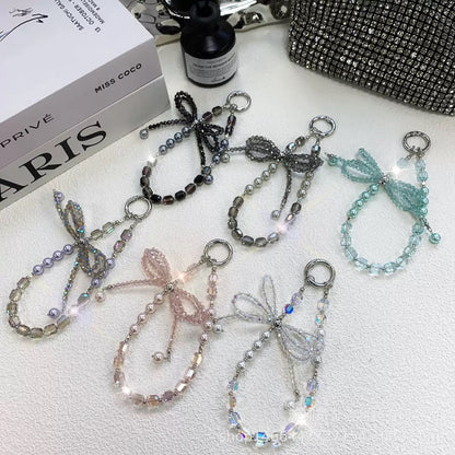 This version positions the product as an ideal gift solution with elegant packaging for special occasions.  Elegant Crystal Bow Phone Chain Gift Set - Luxury Rhinestone Accessory with Detachable Bracelet, Perfect Purse Keychain